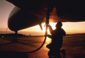 A service technician fuels an airliner.